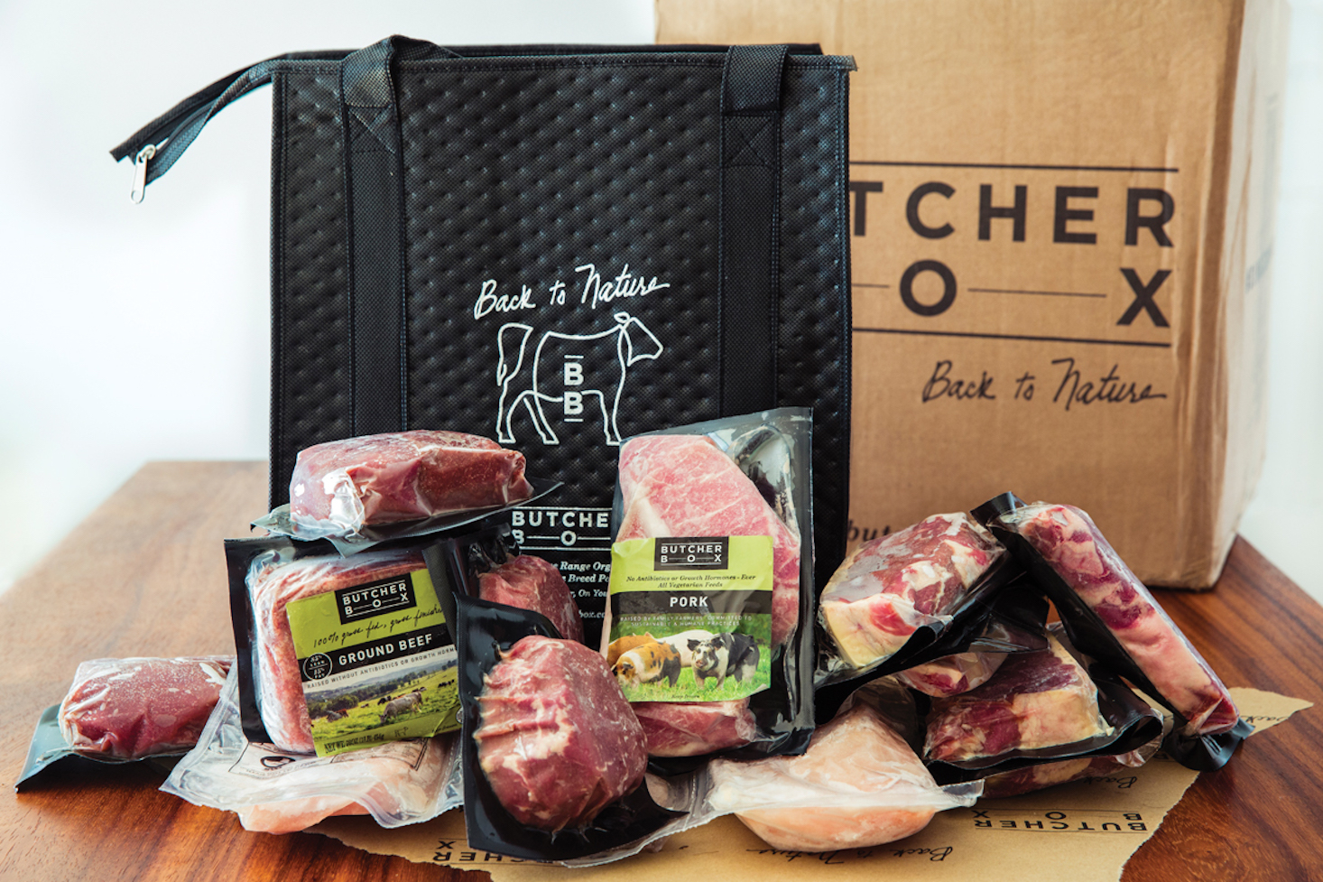 packages of assorted raw meats with cooler bag behind them