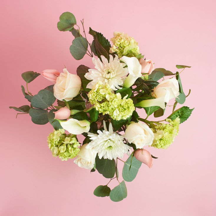 The Deluxe Poetic Bouquet features roses, hydrangea, and eucalyptus.