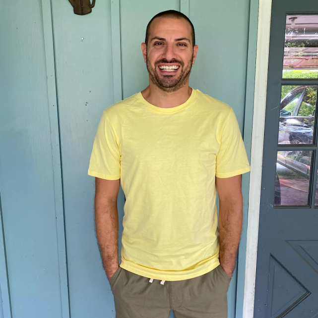 Brandi's husband wearing a bright yellow tee he received from Basic Man.