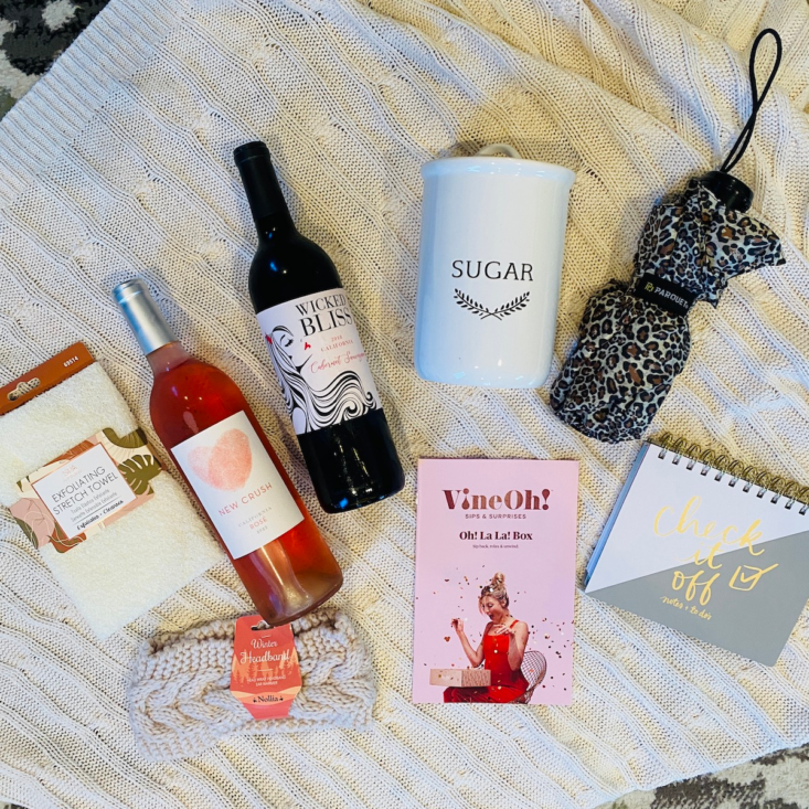 Two bottles of wine along with lifestyle items from VineOh!'s seasonal box.